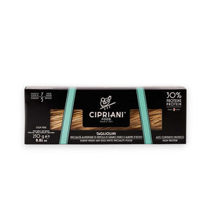 An Atalanta Corporation CIPRIANI - Organic 30% Protein Egg Tagliolini Pasta package. The black box with a turquoise stripe displays the label "CIPRIANI - ORGANIC 30% PROTEIN EGG TAGLIOLINI" and details such as "30% Protein" and "380g." The pasta strands, made from Italian Durum Wheat Semolina, are visible through two transparent sections on the front.
