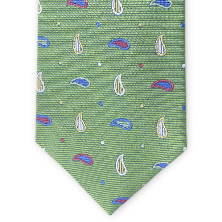 The BIRD DOG BAY PETER-BLAIR Bespoke Paisley Soiree Silk Tie in green features a small paisley pattern in blue, white, and red with colorful dots, handmade and shown rolled up on a white background.
