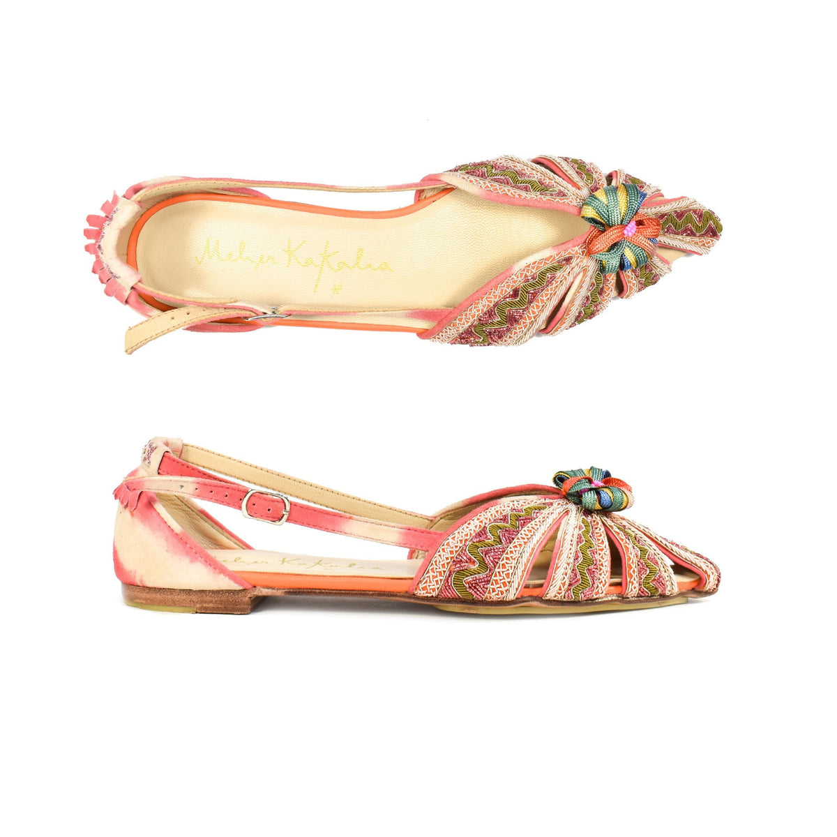 The MEHER KAKALIA - QUEEN DORIS SLING BACK IN PINK YANGTZE offers a colorful, intricately designed flat shoe with a pointed toe inspired by Mughal Royals. It features hand-embroidered multicolored patterns, a decorative knot, side cutouts, and a bright inner lining in vibrant orange, pink, and green tones.