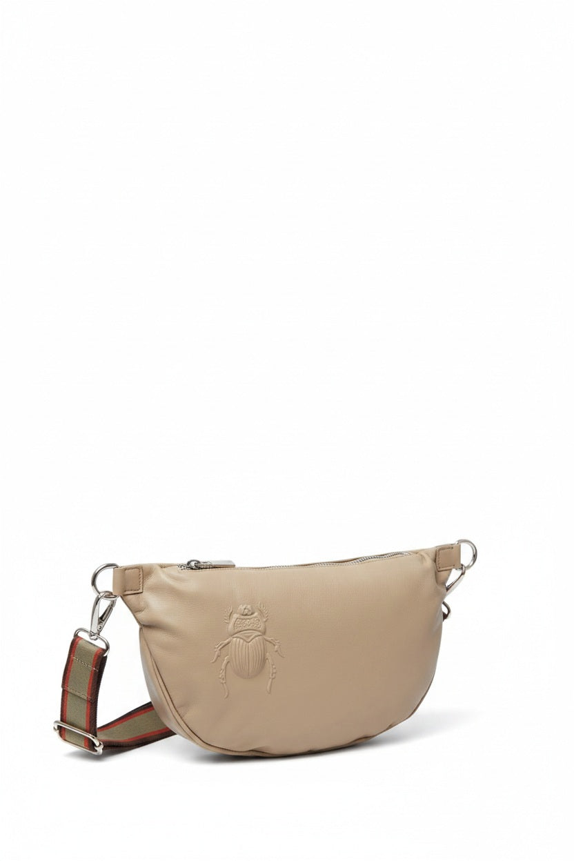 The GABRIELE FRANTZEN - SCARAB BELTBAG XL IN ALMOND, crafted from Italian leather in a beige hue with an embossed scarab design, silver hardware, and a detachable, adjustable striped strap, is displayed on a white background.