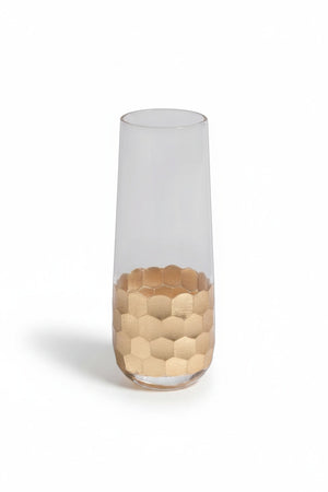 A collection of six glass vessels, including FEZ CUT STEMLESS CHAMPAGNE GLASS WITH GOLD LEAF, flutes, and a glass bottle decanter, each featuring a textured gold leaf honeycomb pattern at the base.