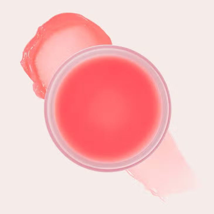 A round, beige container with the lid labeled &quot;JASON WU - GOODNIGHT MR WU LIP MASK&quot; from JASON WU BEAUTY is placed on a pink surface. The container is partially open, revealing a light pink overnight lip mask enriched with Shea Butter inside. An award badge in the top right corner reads &quot;Best of Beauty Allure 2022 Award Winner.