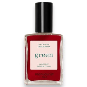 A hand with neatly manicured nails painted in MANUCURIST - GREEN™ NAIL POLISH IN DARK DAHLIA by MANUCURIST INC rests on a light pink, long-sleeve garment. The lighting highlights the glossy finish of the nail polish.