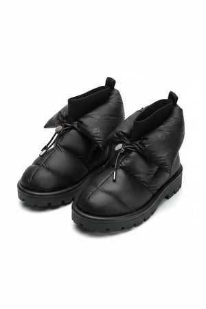 The FLUFIE METALLIC PILLOW BOOT is a pair of gray, insulated slippers with drawstring closures, a high folded collar, water repellent fabric in a subtle circular pattern, designed for warmth and shown on a white background.