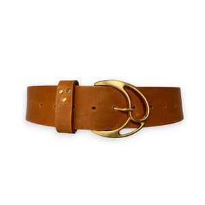 The MONARK BELT by ADA is a brown leather belt with a modern touch, featuring a brass buckle and three gold studs near the loop, stylishly displayed on a white background.