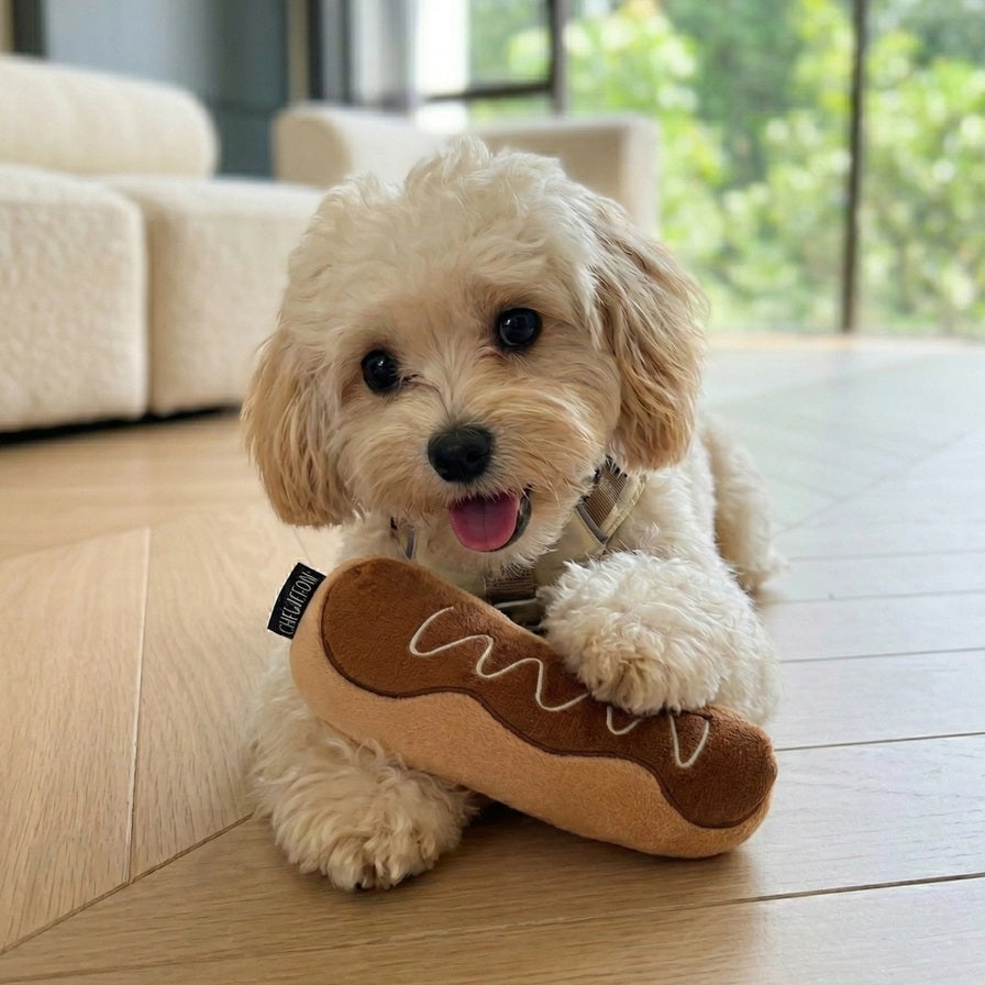 Introducing the CHOCOLATE ÉCLAIR SNUFFLE &amp; CRINKLE DOG TOY from CHEWFFON—a plush, pastry-inspired enrichment toy featuring a soft white interior. This interactive dog toy is gentle on noses and designed for hiding small, colorful treats, encouraging your pup to sniff and search for rewards.