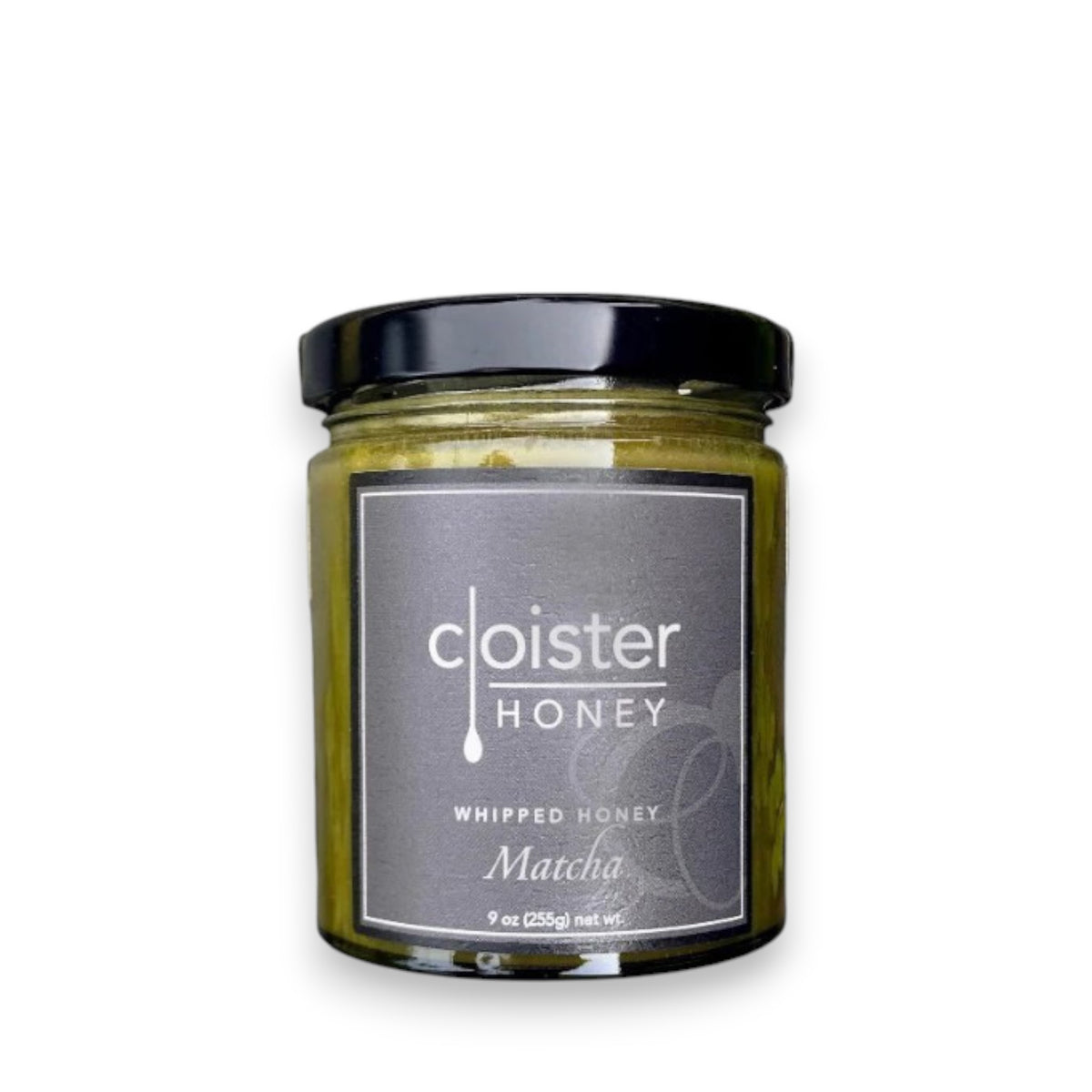 A 9-ounce jar of Cloister Honey - Whipped Matcha Honey is displayed against a white background. The jar features a black lid and a sleek black label with white text that reads "Cloister Honey" at the top and "Whipped Matcha Honey" underneath, blending the elegance of a traditional Japanese tea ceremony with creamy whipped honey.