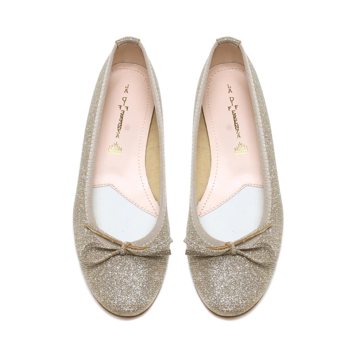 A pair of MICHELE LOPRIORE - MIA BALLET FLAT shoes by MICHELE LOPRIORE, featuring glittery silver leather with small bows on the front, displayed against a plain white background. Made in Italy, these shoes boast a low heel and a sleek, shiny texture.