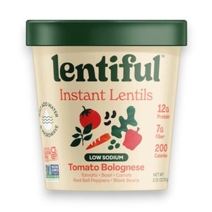A container of LENTIFUL - LOW SODIUM TOMATO BOLOGNESE INSTANT LENTILS by LENTIFUL is surrounded by fresh carrots, spinach, tomatoes, bell pepper, beans, peas, herbs, and red pepper flakes for a heart-healthy meal.