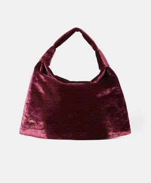 The MOMONI - FRANCOIS VELVET BAG by MOMONI is a teal hobo bag with a slouchy design and a single handle. Made in Italy, it features a small, gold "m" logo on the lower left side. The bag has an overall soft and plush texture, crafted from luxurious crushed viscose velvet.