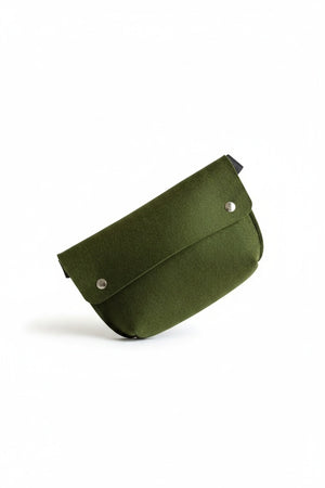 The WOOLBERRY - FELTED WOOL BELT BAG by WOOLBERRY is a small green belt bag crafted from felted wool, featuring a flap secured by two silver snap buttons, and is displayed against a white background.