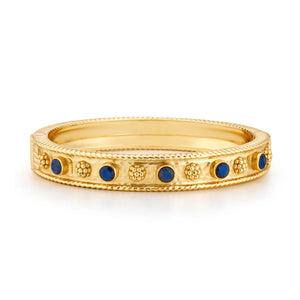 The CAPUCINE DE WULF Berry Gem Classic Hinged Bangle in labradorite features textured 18K gold with small round blue labradorite stones set between raised gold dots around the band.