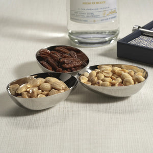 Three connected, polished nickel TRIPLE NUT BOWL alloy bowls arranged in a cluster on a square plate.