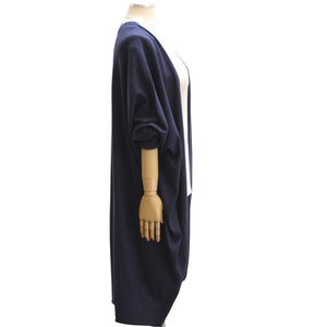 A mannequin showcases the MERSEA - CHELSEA KIMONO, a soft, loose-fitting navy blue short-sleeve cardigan by MERSEA, layered over a plain white top and displayed on a white background.