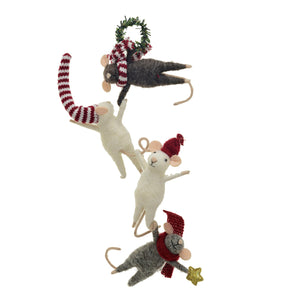 Four CREATIVE COOP FELT MICE HANGING FROM WREATH ornaments, each with red and white winter accessories, lie in a row on a white surface—some hold festive items like a star or wreath.