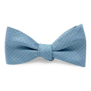 The BIRD DOG BAY PETER-BLAIR - FLOYD SILK BOW TIE IN GREEN features a small circular geometric pattern and adjustable neck, adding refined charm to any outfit. Laid flat on a white background.