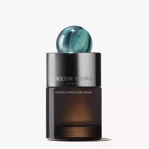A bottle of MOLTON BROWN COASTAL CYPRESS EAU DE PARFUM, featuring a smoky glass base, silver band, and blue marbled cap, is displayed against a plain white background.