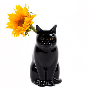 The QUAIL CERAMICS - LUCKY FLOWER VASE SMALL by QUAIL DESIGNS is a glossy black hand-painted stoneware cat figurine with pointed ears and brown eyes, sitting upright against a white background.