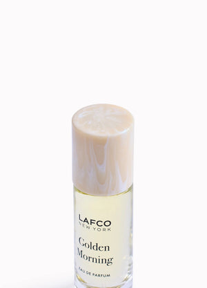 Housed in a clear glass bottle with a beige cap and minimalist black labeling, LAFCO Fine Fragrance Golden Morning 10ml is a floral perfume delicately crafted with essential oils for a fresh, uplifting scent.