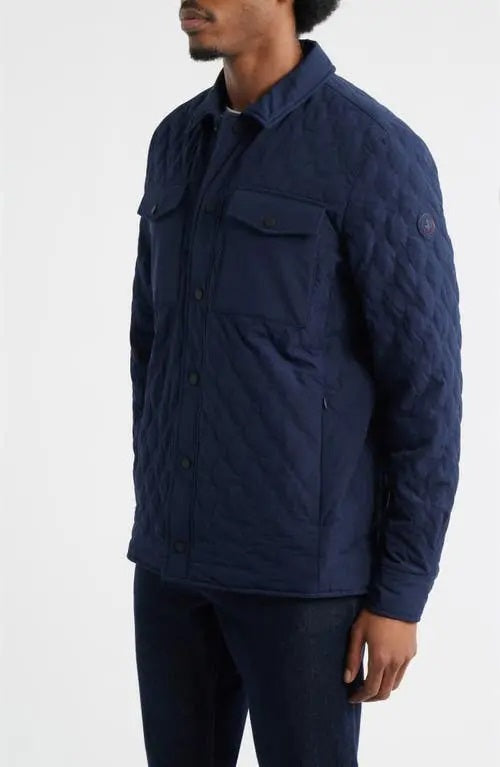 The SAVE THE DUCK ANTON Jacket in navy, made from recycled polyester, features a quilted design, collar, snap buttons, and two chest pockets with flaps, shown on a white background.