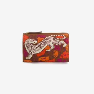 The INOUI EDITIONS - PANTEO COSMETIC BAG by INOUI is a brown zippered pouch made in India, showcasing an illustrated white and brown tiger among orange, red, and purple floral patterns on the front.