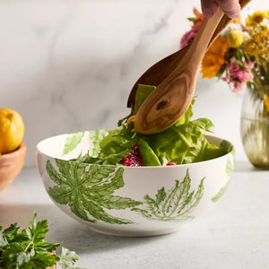 The CASKATA Freya Vegetable Serving Bowl, crafted from white porcelain with green botanical leaf patterns inside and out, is displayed on a plain white background—an elegant and practical addition by CASKATA.