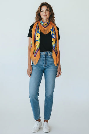 The FRANCO FERRARI - SILK FRINGE SCARF is an Italian-made luxury accessory, featuring bright blue silk with large yellow flowers, green leaves, purple and red borders, and long golden fringe on the edges.