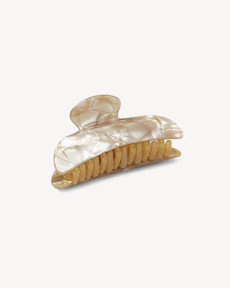 The MACHETE - MIDI HEIRLOOM CLAW by MACHETE is featured against a plain white background. This cream-colored hair accessory is crafted from luxurious Italian acetate and features curved edges with interlocking teeth, making it ideal for securing medium hair with effortless style.