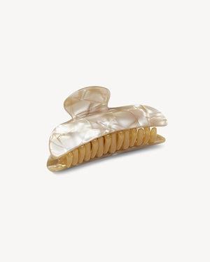 The MACHETE - MIDI HEIRLOOM CLAW by MACHETE is featured against a plain white background. This cream-colored hair accessory is crafted from luxurious Italian acetate and features curved edges with interlocking teeth, making it ideal for securing medium hair with effortless style.