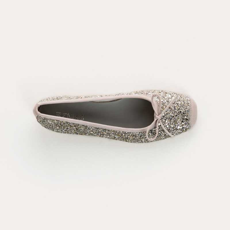 The REQINS Harmony Sequin Ballerina Flats in Ice feature silver glitter, a front bow, and a low heel, shown in side view against a plain light background.