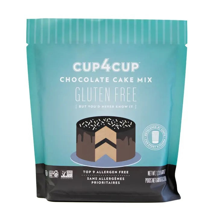 The CUP4CUP GLUTEN FREE CHOCOLATE CAKE MIX package by CUP4CUP features a cake illustration and showcases its top 9 allergen-free formulation, premium gluten free flour, and non-GMO ingredients. The packaging has a teal background with white and brown text and design elements.