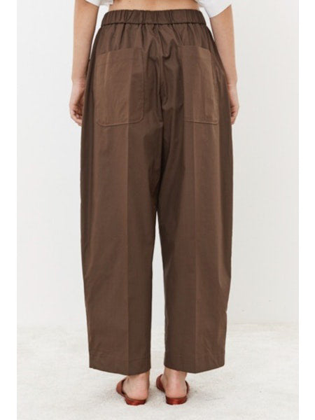 Close-up of MEIMEIJ - PULL ON COTTON PANT fabric showing a grid-like pattern and visible weave with intersecting threads. The slightly coarse, muted brown texture gives it a natural, earthy appearance that embodies minimalist elegance. Ideal for crafting stylish cotton pants by MEIMEIJ.