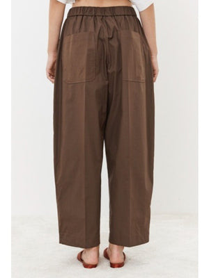 Close-up of MEIMEIJ - PULL ON COTTON PANT fabric showing a grid-like pattern and visible weave with intersecting threads. The slightly coarse, muted brown texture gives it a natural, earthy appearance that embodies minimalist elegance. Ideal for crafting stylish cotton pants by MEIMEIJ.