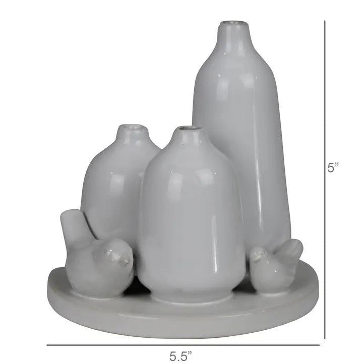 The HOMART CERAMIC VASE TRIO WITH TWO BIRDS features three matte white minimalist vases of varying heights and two bird figurines on a 5.5-inch round base; tallest vase stands 5 inches—ideal for bird vase decor.