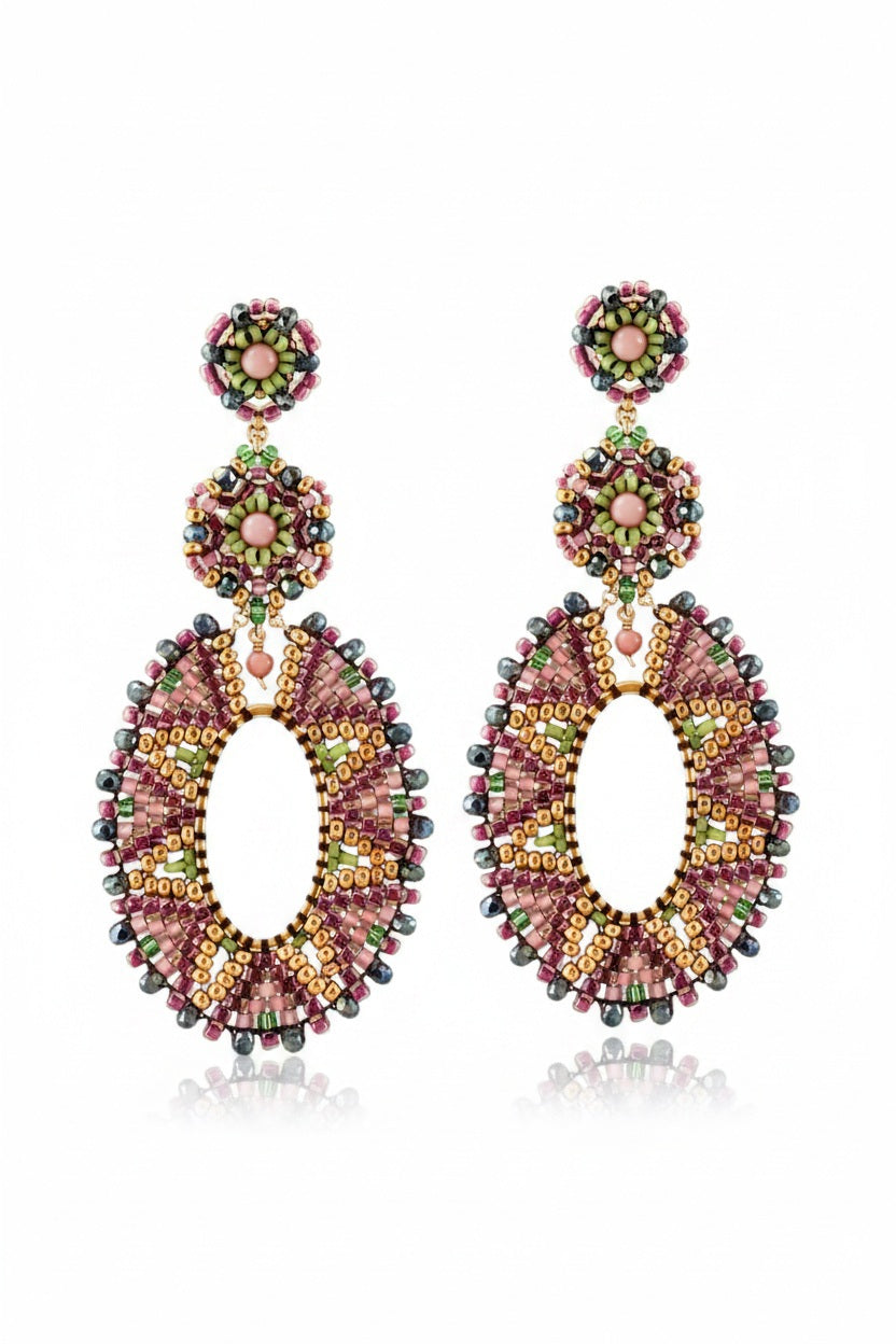 The MIGUEL ASES - CRYSTAL MIYUKI BEAD EARRINGS by MIGUEL ASES, INC. are colorful oval drop earrings featuring intricate Miyuki beadwork with pink, green, gold, and pearl accents and a botanical-inspired floral motif at the top.