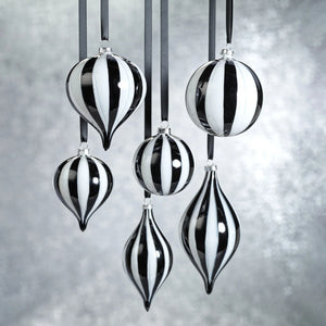 ZODAX TWILIGHT STRIPE GLASS ORNAMENT: a 4-inch diameter glass ornament featuring alternating black and white vertical stripes, hanging from a grey ribbon.