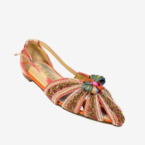 The MEHER KAKALIA - QUEEN DORIS SLING BACK IN PINK YANGTZE offers a colorful, intricately designed flat shoe with a pointed toe inspired by Mughal Royals. It features hand-embroidered multicolored patterns, a decorative knot, side cutouts, and a bright inner lining in vibrant orange, pink, and green tones.