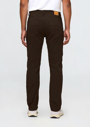 DU/ER - NO SWEAT STRAIGHT PANTS IN STOUT by DUER: Straight-leg, dark brown pants made from No Sweat fabric with front and back pockets, belt loops, and a button closure, shown on a white background.
