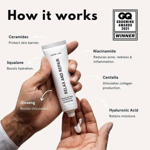 A white tube labeled "JAXON LANE - RELAX AND REPAIR ANTI AGING FACE MOISTURIZER" stands beside a matching black box. This fragrance-free men's moisturizer from JAXON LANE contains 2.03 fl. oz. (60 ml) of product.