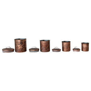 A top view of the CREATIVE COOP STAINLESS STEEL CANISTERS IN OXIDIZED COPPER FINISH, SET OF 4, featuring matching copper lids and arranged symmetrically on a white background.