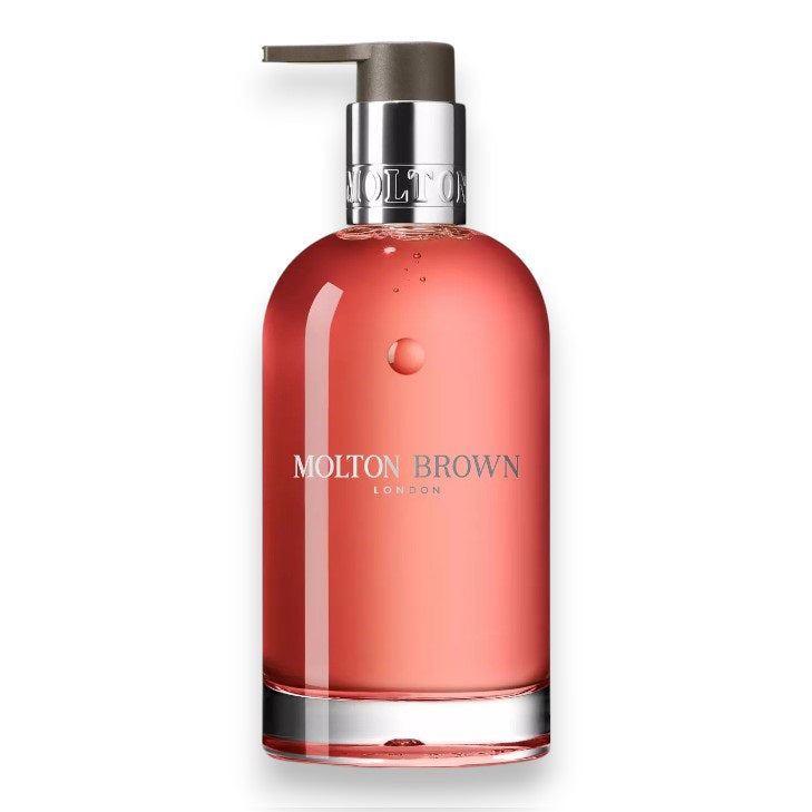 A clear bottle of MOLTON BROWN - GINGERLILY HAND WASH with a silver collar, pump dispenser, and pink soap is shown on a white background.