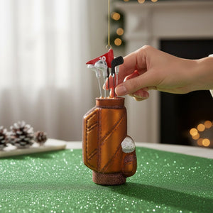 Cody Foster glass golf bag ornament, measuring 2.5 x 1.5 x 6 inches, containing several clubs and a red flag marked with the number 10.