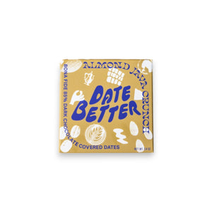 Three DATE BETTER - ALMOND JAVA CRUNCH COVERED DATES, by DATE BETTER SNACKS, arranged on a dark slate surface offer a deliciously healthy candy alternative.
