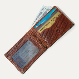 The WILL LEATHER GOODS Industrialist Billfold in Ginger Pindot is shown closed on a white background, featuring full-grain leather and a subtle embossed animal logo at the top right corner.