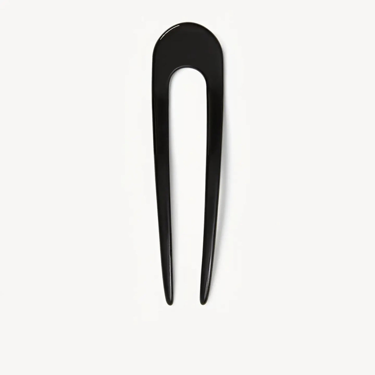 The MACHETE - FRENCH HAIR PIN IN BLACK by MACHETE, a handcrafted black hair accessory, is displayed vertically against a plain white background.