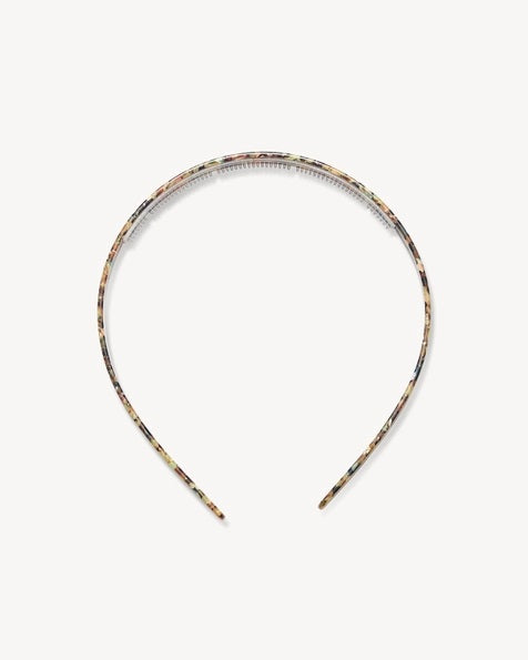 The MACHETE Ultralight Thin Headband in Monet, featuring a multicolored marbled pattern, rests on a plain light background.