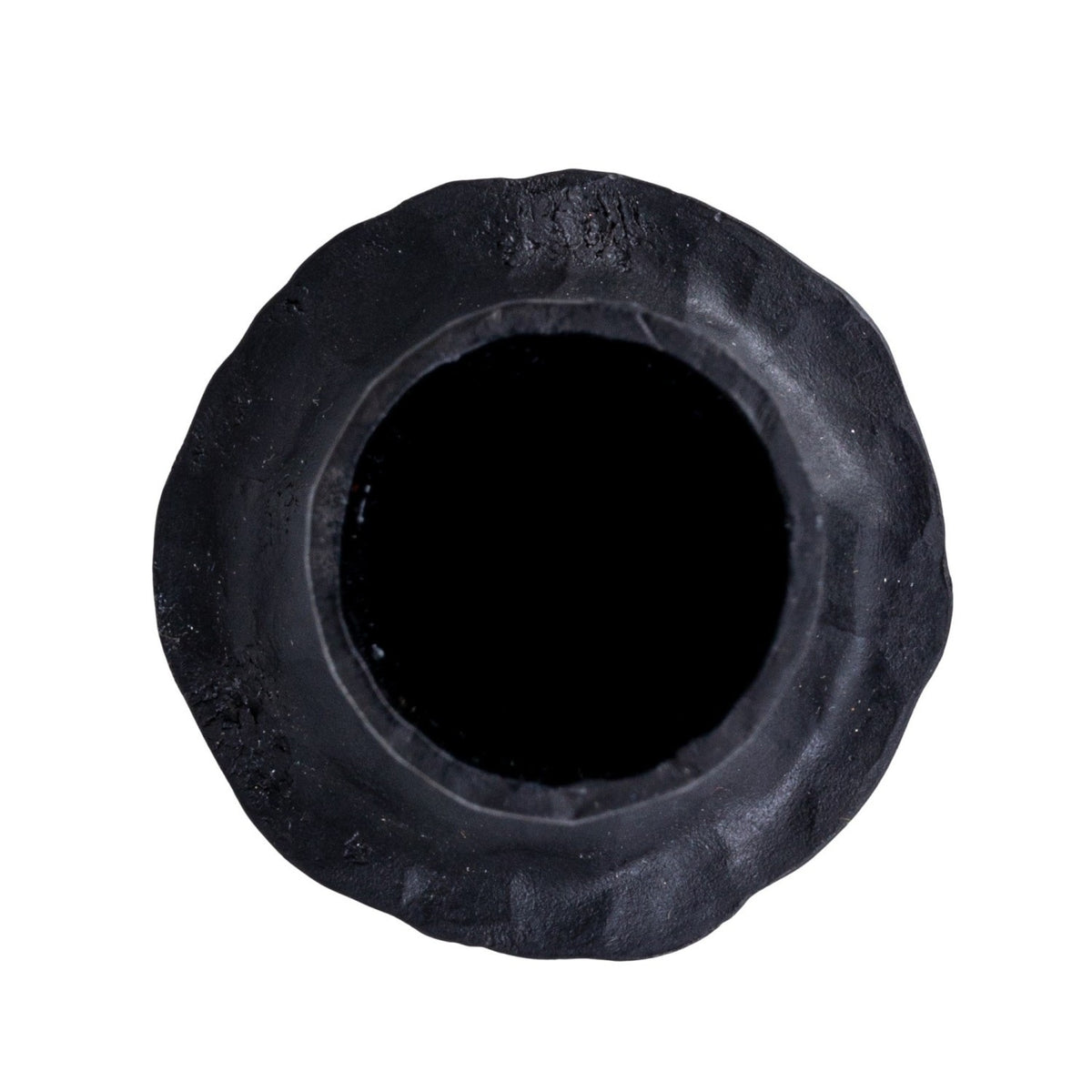 The CREATIVE COOP HAND-FORGED CAST IRON TAPER HOLDER in black features a hammered texture, wide flared base, and slender cylindrical top—ideal for industrial decor and shown upright against a plain white background.