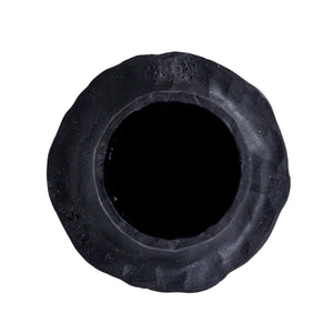 The CREATIVE COOP HAND-FORGED CAST IRON TAPER HOLDER in black features a hammered texture, wide flared base, and slender cylindrical top—ideal for industrial decor and shown upright against a plain white background.