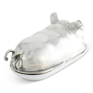 The VAGABOND HOUSE Pewter Happy Pig Butter Dish, a luxury-grade piece by VAGABOND HOUSE, gleams beside a white plate with butter and two slices, its lid open against a pristine white backdrop.