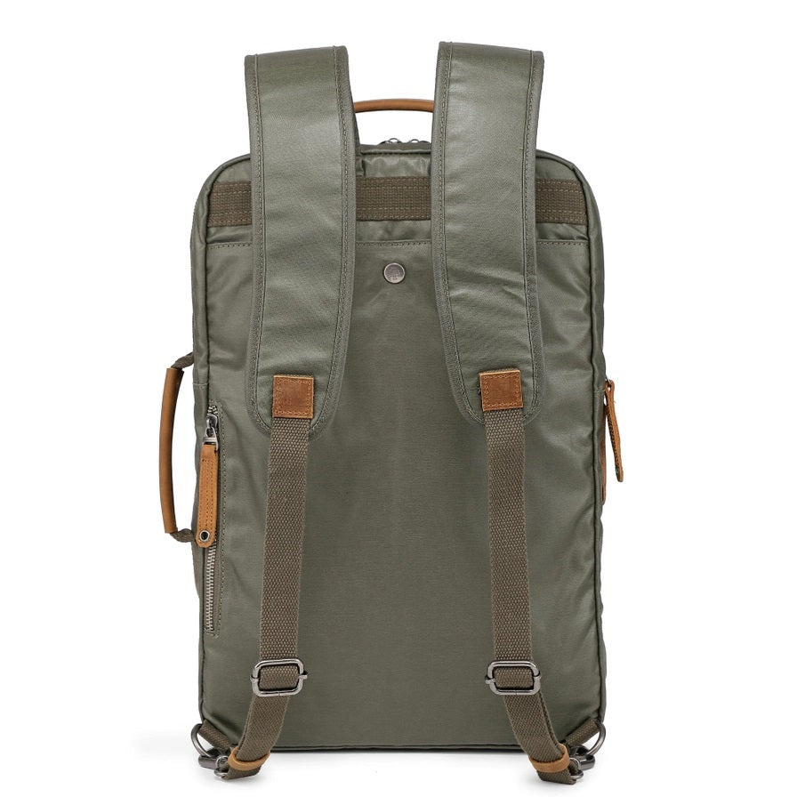 The TSD BRAND Madrone Coated Canvas Backpack in army green features brown leather accents, zippers, a top flap, side handles, metal rings, and a leather logo patch; shown lying flat to display these details.